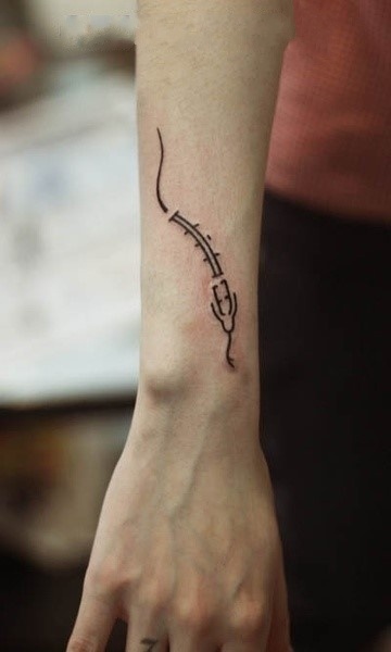 small snake tattoo on arm