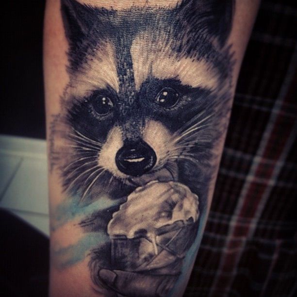 Adorable eating raccoon tattoo