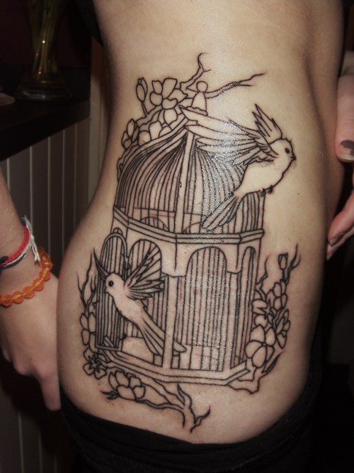 Amazing birdcage side tattoo