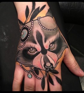 Amazing raccoon face hand tattoo