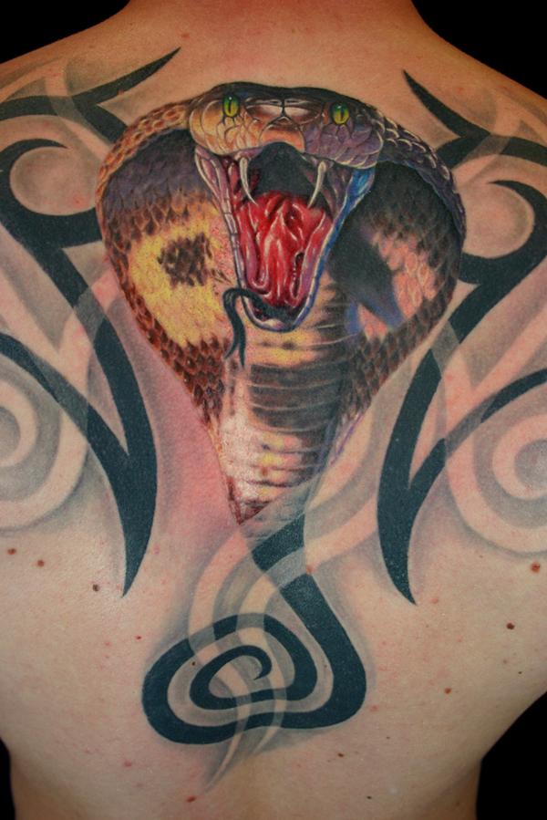 Atacking cobra back tattoo