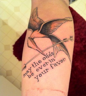 Awesome mockingjay with quote tattoo