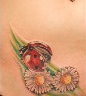 Beautiful ladybug and flower tattoo