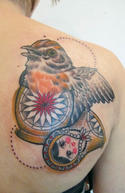 Bird inside matryoshka tattoo