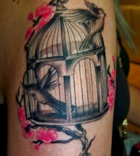Birdcage and cherry blossom tattoo