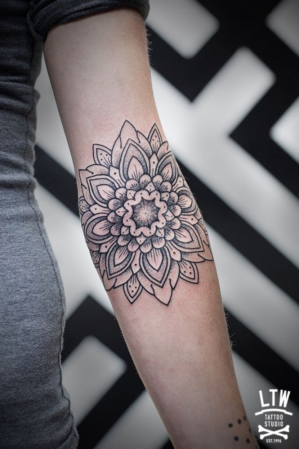 Black adorable hand’s mandala tattoo