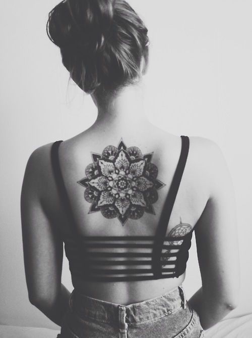 Black girl’s back mandala tattoo