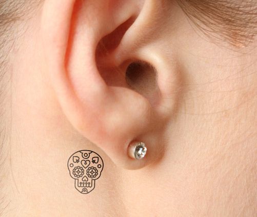 Black skull tiny tattoo
