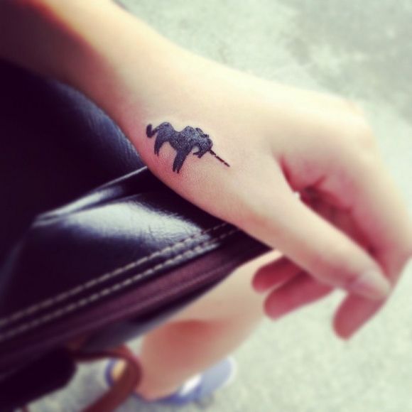 Black wrist unicorn tattoo