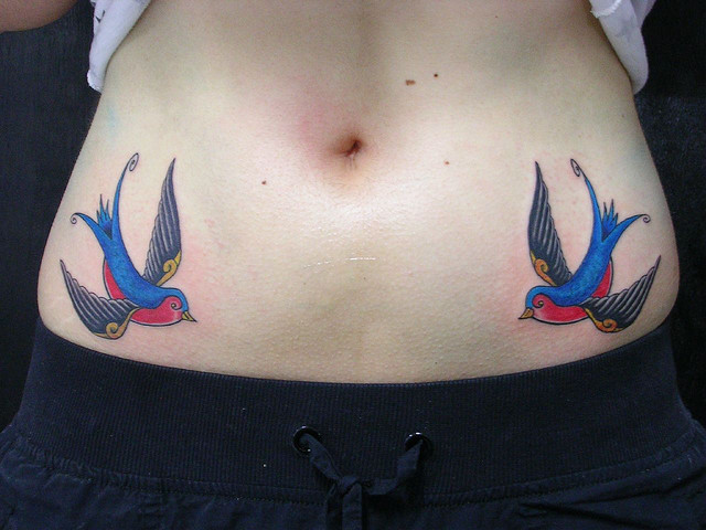 Blue and red swallow tattoo