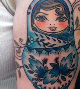 Blue matryoshka arm tattoo