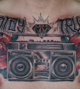 Boombox and roses chest tattoo