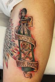 Bottle and quote leg tattoo