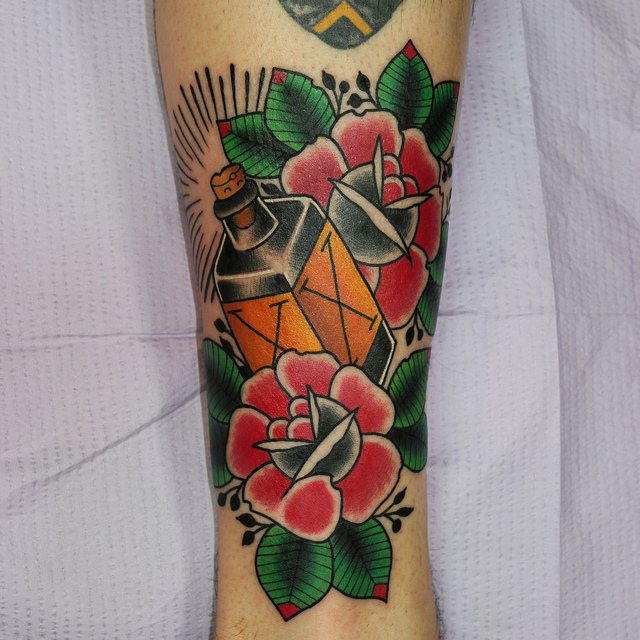 Bottle of poison and roses tattoo