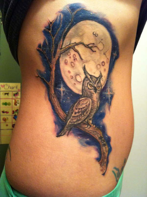 Brilliant owl on a branch tattoo