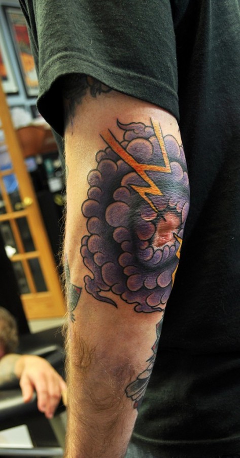 Cloud and lightning elbow tattoo