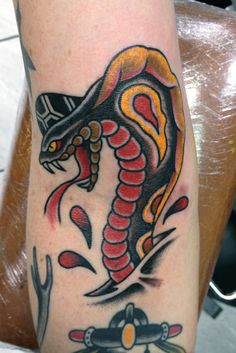 Coloured cobra arm tattoo