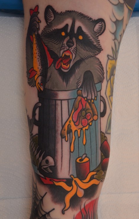 Coloured eating raccoon tattoo