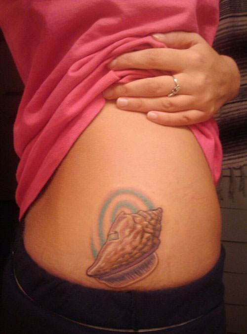 Coloured shell hip tattoo