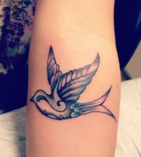 Coloured swallow arm tattoo