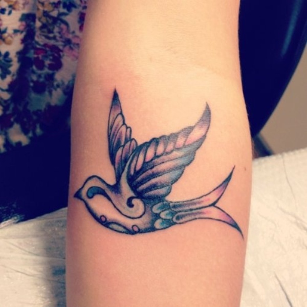 Coloured swallow arm tattoo