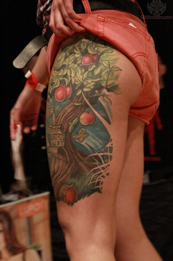 Colourful apple tree leg tattoo