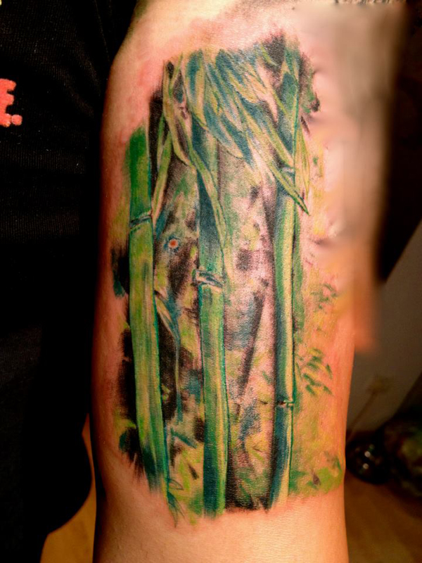 Colourful bamboo arm tattoo