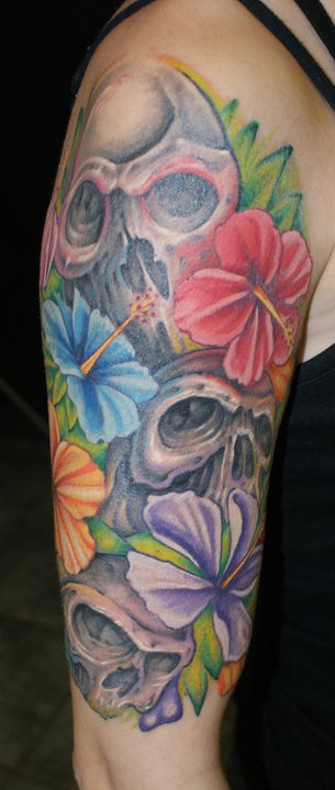 Colourful flowers and skulls tattoo