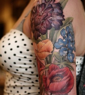 Colourful flowers tattoo by Alice Kendall