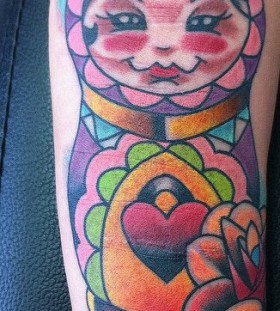 Colourful matryoshka arm tattoo