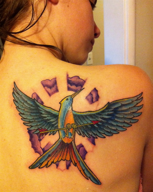 Colourful mockingjay back tattoo