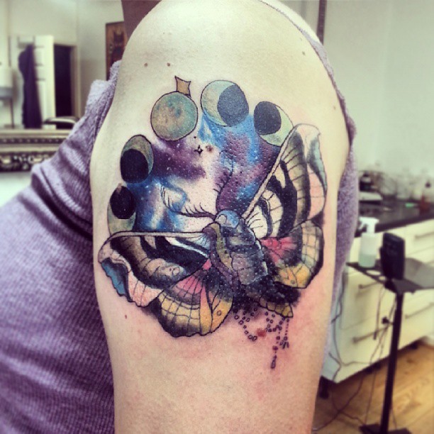 Colourful moth sleeve tattoo