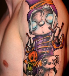 Colourful puppet master arm tattoo