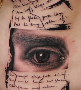 Cool eye and writing tattoo by Florian Karg