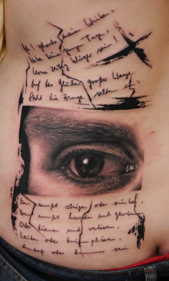 Cool eye and writing tattoo by Florian Karg