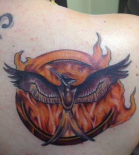 Cool flaming mockingjay back tattoo