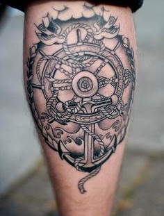 Creative wheel and anchor tattoo