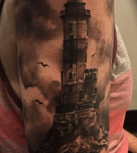 Creepy lighthouse arm tattoo