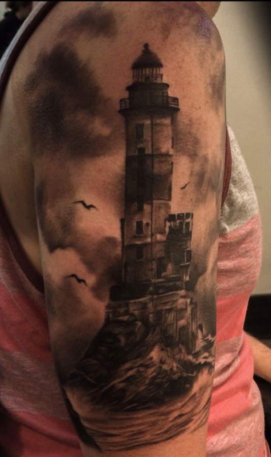 Creepy lighthouse arm tattoo