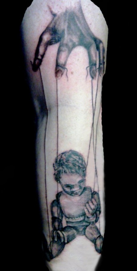 Creepy puppet leg tattoo