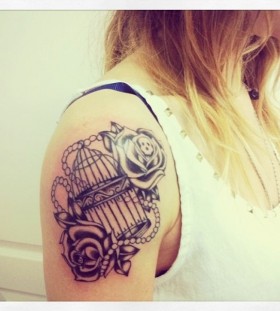 Cute birdcage arm tattoo
