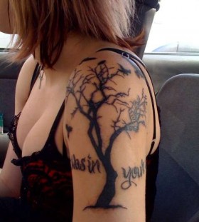 Dead tree arm tattoo