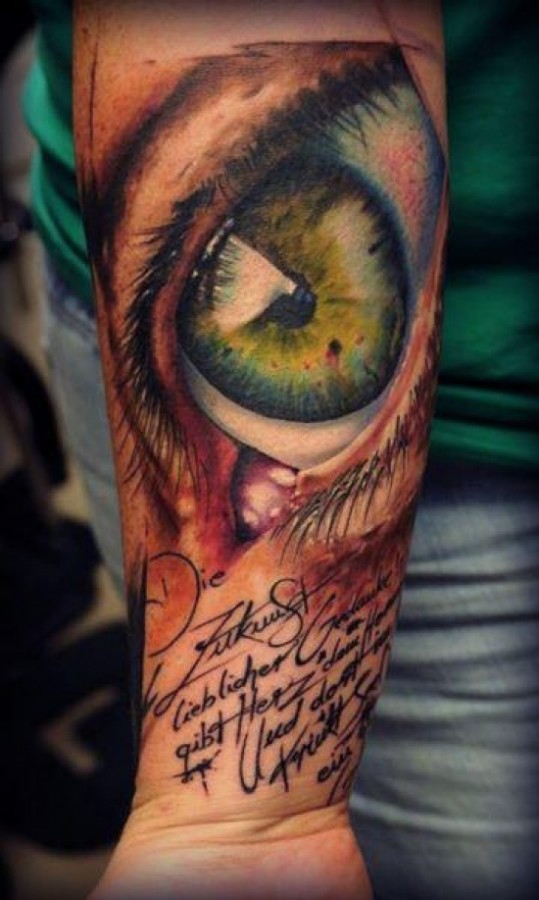 Eye and writing tattoo by Florian Karg