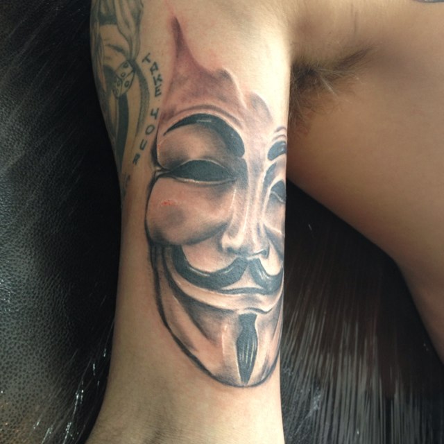 Face of V arm tattoo