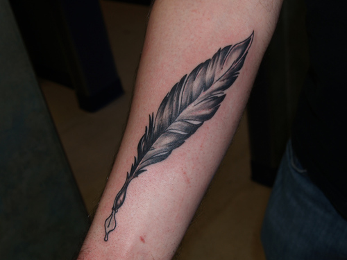 Feather pen arm tattoo