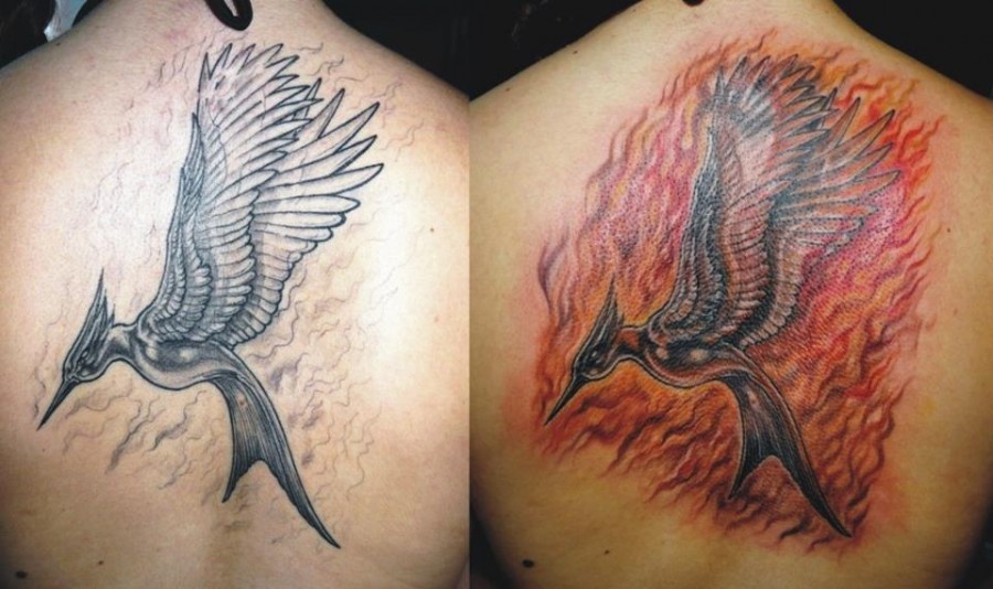 Flaming mockingjay back tattoo