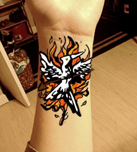 Flaming mockingjay wrist tattoo