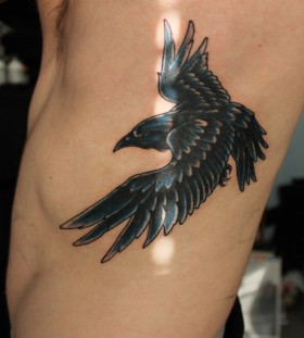 Flying raven side tattoo