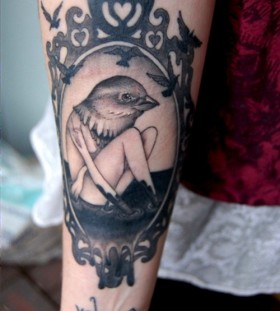 Girl with a birds head frame tattoo