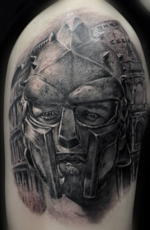 Gladiator’s face arm tattoo